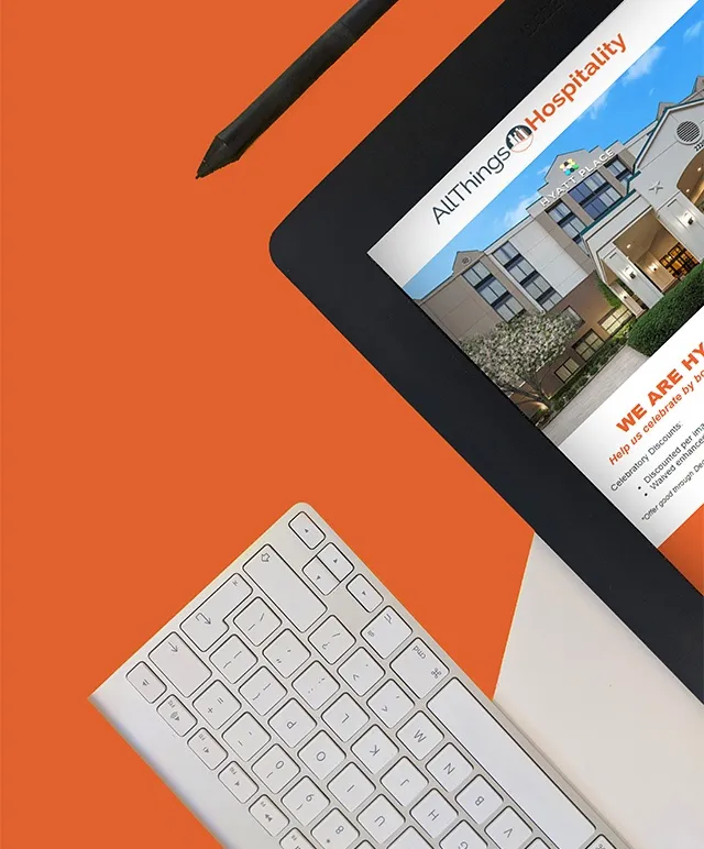 A tablet with the ATH website on an orange field with a stylus and keyboard next to it.